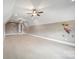Large bonus room with ceiling fans and playful wall decorations at 8825 Harris Rd, Concord, NC 28027