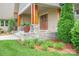 Charming front porch with stone accents, wooden columns, and double-door entrance at 8825 Harris Rd, Concord, NC 28027