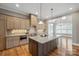 Modern kitchen featuring a large island, stainless steel appliances, custom cabinets and an open floorplan at 8825 Harris Rd, Concord, NC 28027