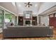 Comfortable living room with a stone fireplace, wooden floors, built-in shelves, and backyard views at 8825 Harris Rd, Concord, NC 28027