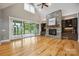 Bright living room featuring vaulted ceilings, hardwood floors, and stone fireplace at 8825 Harris Rd, Concord, NC 28027