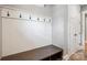 Mudroom with bench, coat hooks, wainscotting, and access to other rooms at 8825 Harris Rd, Concord, NC 28027