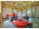 Spacious outbuilding interior with high ceilings and large garage door and various machines at 8825 Harris Rd, Concord, NC 28027