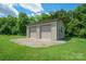 Exterior view of an outbuilding with two garage doors and gravel foundation at 8825 Harris Rd, Concord, NC 28027