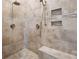 Walk-in shower featuring dual showerheads, tile walls, and a built-in bench at 8825 Harris Rd, Concord, NC 28027