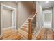 Elegant staircase with hardwood steps, wrought iron spindles, and natural light at 8825 Harris Rd, Concord, NC 28027