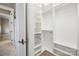 Organized walk-in closet with custom shelving and hanging rods for optimal storage at 8825 Harris Rd, Concord, NC 28027