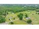 Expansive aerial view showing a rural landscape with homes, green fields, and dense woodlands in a serene setting at 9161 Paul Payne Store Rd, Stony Point, NC 28678
