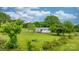 Well-maintained single-story home featuring white siding, a cozy front porch, and a spacious, lush green lawn with mature trees at 9161 Paul Payne Store Rd, Stony Point, NC 28678