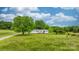 Beautiful home on a large lot featuring well-kept lawns, mature trees, and a welcoming front entrance at 9161 Paul Payne Store Rd, Stony Point, NC 28678