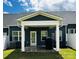 Back porch featuring dark siding, white columns, and a grill, creating an inviting outdoor space at 934 Prince Garrett Way, Denver, NC 28037
