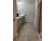 Bright bathroom with double vanity, gray cabinets, and neutral tile flooring, offering a serene ambiance at 934 Prince Garrett Way, Denver, NC 28037