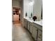 Elegant bathroom with a double vanity, walk-in closet, neutral walls and tile flooring, offering storage at 934 Prince Garrett Way, Denver, NC 28037