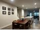 Open concept dining area with wood table, stylish seating, and seamless access to kitchen and living spaces at 934 Prince Garrett Way, Denver, NC 28037