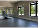 Bright fitness center with floor-to-ceiling mirror and natural light at 934 Prince Garrett Way, Denver, NC 28037