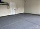 Clean garage with epoxy floor, white walls, and ample space for parking and storage at 934 Prince Garrett Way, Denver, NC 28037