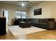 Cozy living room boasts a sectional sofa, plush rug, ceiling fan, and ample natural light at 934 Prince Garrett Way, Denver, NC 28037