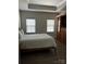 Serene bedroom features a tray ceiling, neutral walls, and built-in storage, creating a tranquil retreat at 934 Prince Garrett Way, Denver, NC 28037