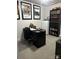 Well-lit office space featuring a sleek black desk, ample storage, and a collection of classic movie posters at 934 Prince Garrett Way, Denver, NC 28037