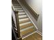 Staircase featuring wooden steps, white risers, and a light wood railing at 934 Prince Garrett Way, Denver, NC 28037