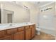Bathroom features double sink vanity, tile floor and shower-tub combo at 9430 Duckhorn Dr, Charlotte, NC 28277