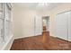 Bedroom with hardwood floors, a closet, and a large window for natural light at 9430 Duckhorn Dr, Charlotte, NC 28277