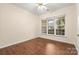 Bedroom featuring ceiling fan, hardwood floors, and windows overlooking the yard at 9430 Duckhorn Dr, Charlotte, NC 28277