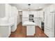 Bright kitchen with white cabinets, stainless appliances, subway tile backsplash and hardwood floors at 9430 Duckhorn Dr, Charlotte, NC 28277