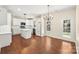 Bright kitchen with white cabinetry, quartz countertops, island, and stainless appliances at 9430 Duckhorn Dr, Charlotte, NC 28277