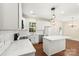 Modern kitchen with white cabinets, quartz countertops, and stainless steel appliances at 9430 Duckhorn Dr, Charlotte, NC 28277