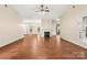 Living room with hardwood floors, fireplace, ceiling fan, and doorway to dining room at 9430 Duckhorn Dr, Charlotte, NC 28277