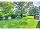 Spacious backyard featuring green grass, shrubbery, and a shed at 983 Willowbrook Ave, Rock Hill, SC 29730