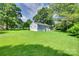 Spacious backyard featuring lush green grass and mature trees at 983 Willowbrook Ave, Rock Hill, SC 29730