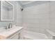 Bright bathroom featuring a modern vanity with white cabinets and white-tiled shower-tub combination at 983 Willowbrook Ave, Rock Hill, SC 29730