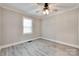 Empty bedroom featuring a ceiling fan, neutral paint, white trim, and light wood flooring at 983 Willowbrook Ave, Rock Hill, SC 29730