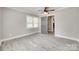Empty bedroom featuring a ceiling fan, neutral paint, white trim, and light wood flooring at 983 Willowbrook Ave, Rock Hill, SC 29730