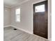 Bright entryway featuring a modern wood door with decorative window pane and new flooring at 983 Willowbrook Ave, Rock Hill, SC 29730