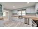 Bright kitchen with stainless steel appliances, butcher block counters, and light blue cabinets at 983 Willowbrook Ave, Rock Hill, SC 29730