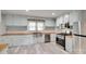 Well-lit kitchen featuring stainless steel appliances, butcher block countertops, and light blue cabinetry at 983 Willowbrook Ave, Rock Hill, SC 29730