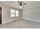 Bright room with large windows, ceiling fan, and hardwood-style flooring at 983 Willowbrook Ave, Rock Hill, SC 29730