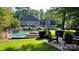 Spacious backyard with a pool, spa, lounge chairs, lush lawn, and privacy fencing at 10338 Hollybrook Dr, Charlotte, NC 28277
