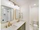 Bright bathroom featuring double sinks, gold fixtures, modern lighting, and a tiled shower at 10338 Hollybrook Dr, Charlotte, NC 28277