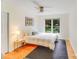 Bright bedroom featuring a ceiling fan, a large window, and wooden floors at 10338 Hollybrook Dr, Charlotte, NC 28277