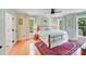 Comfortable bedroom with two large windows, ceiling fan and wood floors at 10338 Hollybrook Dr, Charlotte, NC 28277