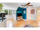 Upstairs bonus room with blue accent wall, hardwood floors and white trim at 10338 Hollybrook Dr, Charlotte, NC 28277