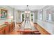 Elegant dining room with hardwood floors, large windows with floral curtains, and a stylish chandelier at 10338 Hollybrook Dr, Charlotte, NC 28277