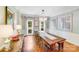 Elegant dining room with hardwood floors, large windows with floral curtains, and a modern chandelier at 10338 Hollybrook Dr, Charlotte, NC 28277
