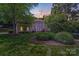 Charming two-story home with manicured lawn and lush landscaping, creating great curb appeal at 10338 Hollybrook Dr, Charlotte, NC 28277