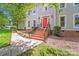 Beautiful home exterior showcasing brick stairs leading to a bright red front door at 10338 Hollybrook Dr, Charlotte, NC 28277