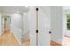 Upstairs hallway with access to multiple rooms, hardwood flooring and white trim at 10338 Hollybrook Dr, Charlotte, NC 28277